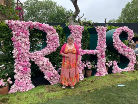 Liz Zorab standing in front of RHS sign