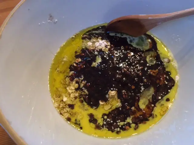 Combining eggs and sugar in a bowl.