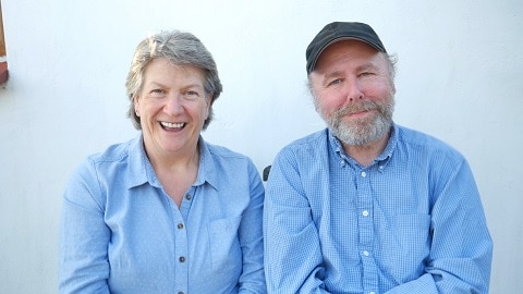 Liz and Mr J in coordinating blue shirts, smiling and laughing
