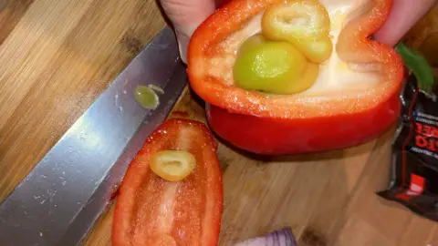 Multiple baby peppers growing inside a pepper